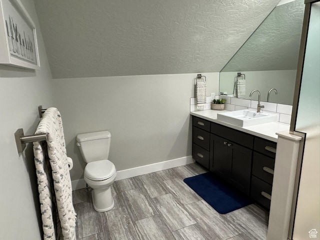 142 S 3500 W, Maeser, UT 84078 - bathroom featuring a textured ceiling, baseboards, toilet, vanity, and lofted ceiling