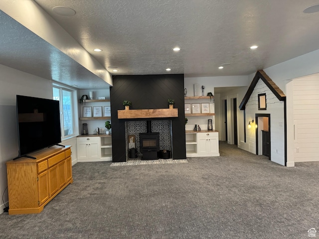 142 S 3500 W, Maeser, UT 84078 - living room with dark colored carpet, a wood stove, recessed lighting, and a textured ceiling