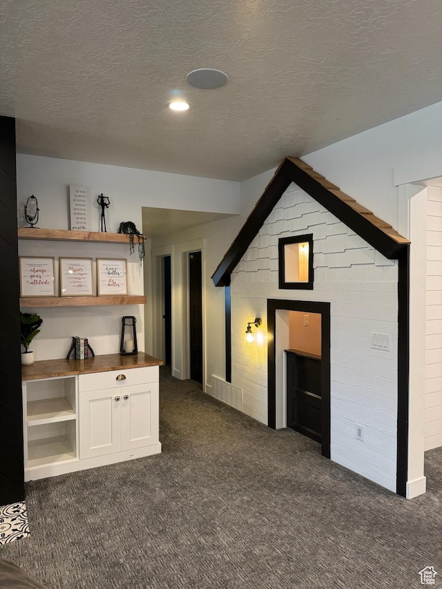 142 S 3500 W, Maeser, UT 84078 - unfurnished living room with dark colored carpet and a textured ceiling
