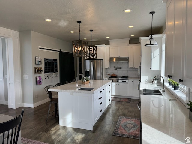 142 S 3500 W, Maeser, UT 84078 - kitchen with a barn door, a sink, stainless steel appliances, and under cabinet range hood