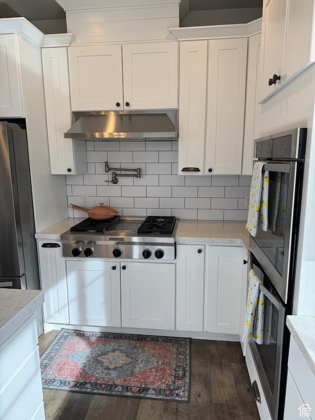 142 S 3500 W, Maeser, UT 84078 - kitchen with under cabinet range hood, white cabinetry, and appliances with stainless steel finishes