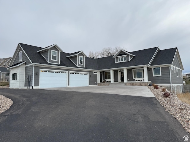 new england style home featuring aphalt driveway