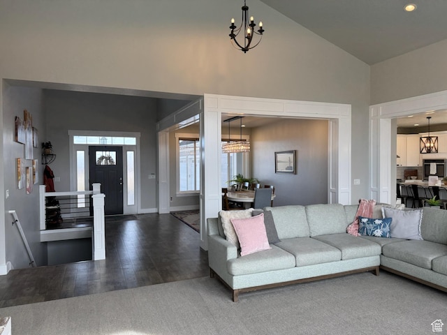 142 S 3500 W, Maeser, UT 84078 - living room with baseboards, dark wood-style flooring, high vaulted ceiling, and a notable chandelier