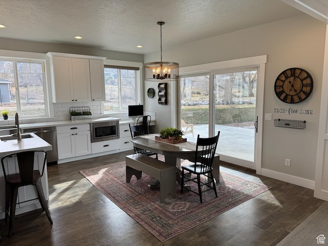 142 S 3500 W, Maeser, UT 84078 - dining room with baseboards, dark wood-style flooring, a chandelier, and recessed lighting