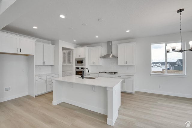 6161 W Teton Ranch Dr Unit 342, Herriman, UT 84096 - kitchen featuring wall chimney range hood, appliances with stainless steel finishes, a sink, decorative backsplash, and recessed lighting