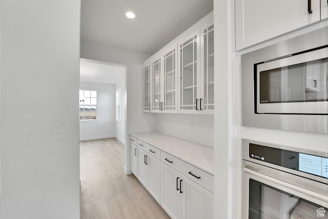 6161 W Teton Ranch Dr Unit 342, Herriman, UT 84096 - bar with appliances with stainless steel finishes, recessed lighting, baseboards, tasteful backsplash, and light wood finished floors