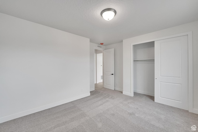 6161 W Teton Ranch Dr Unit 342, Herriman, UT 84096 - unfurnished bedroom featuring baseboards, carpet floors, a closet, and a textured ceiling