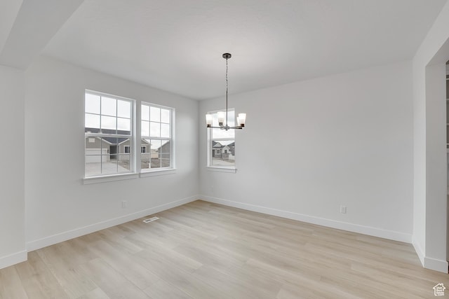 6161 W Teton Ranch Dr Unit 342, Herriman, UT 84096 - unfurnished dining area featuring a chandelier, light wood-style floors, and baseboards
