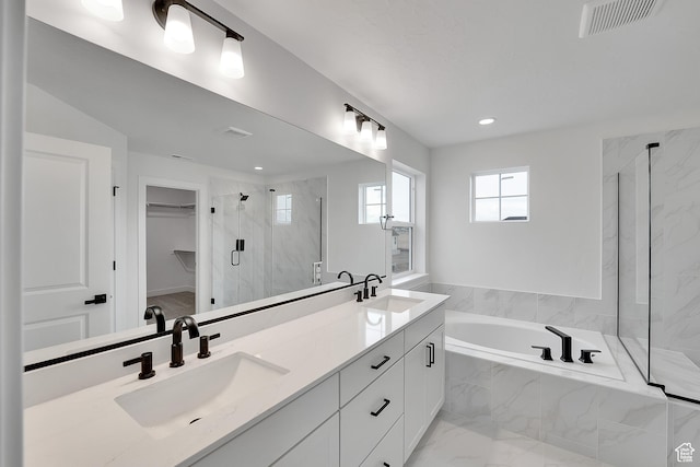 6161 W Teton Ranch Dr Unit 342, Herriman, UT 84096 - bathroom featuring a marble finish shower, a garden tub, double vanity, recessed lighting, and a walk in closet