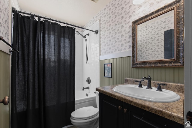 2599 S Foxridge Rd, Garden City, UT 84028 - bathroom featuring wallpapered walls, toilet, vanity, shower / bath combo with shower curtain, and wainscoting