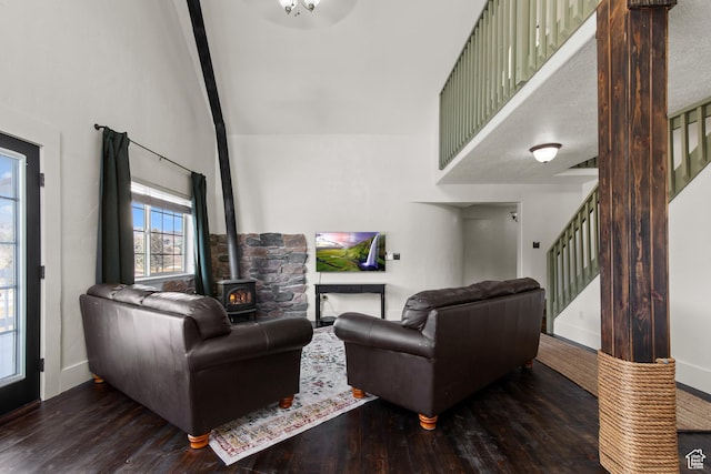 2599 S Foxridge Rd, Garden City, UT 84028 - living area featuring stairs, a wood stove, high vaulted ceiling, baseboards, and wood finished floors