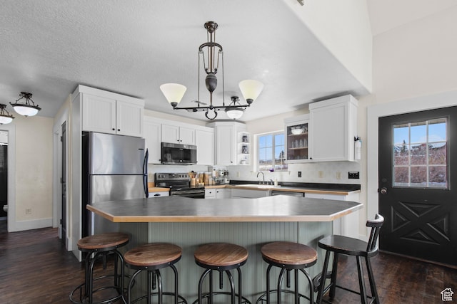 2599 S Foxridge Rd, Garden City, UT 84028 - kitchen with a sink, white cabinetry, appliances with stainless steel finishes, and dark wood-style floors