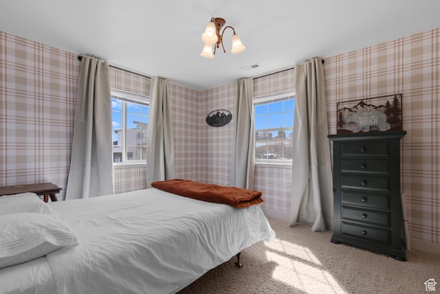 2599 S Foxridge Rd, Garden City, UT 84028 - carpeted bedroom featuring visible vents, wallpapered walls, and multiple windows