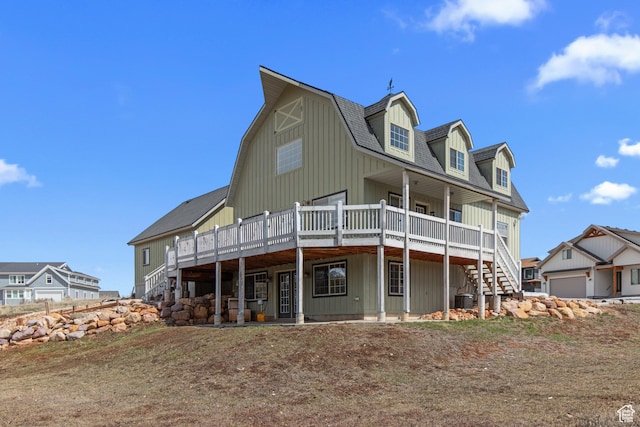 2599 S Foxridge Rd, Garden City, UT 84028 - back of property with a gambrel roof, a deck, central air condition unit, and stairs