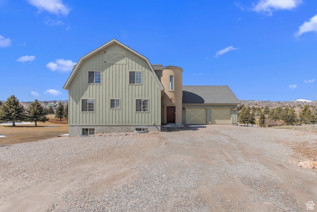 2599 S Foxridge Rd, Garden City, UT 84028 - view of front of house featuring dirt driveway, an attached garage, and board and batten siding