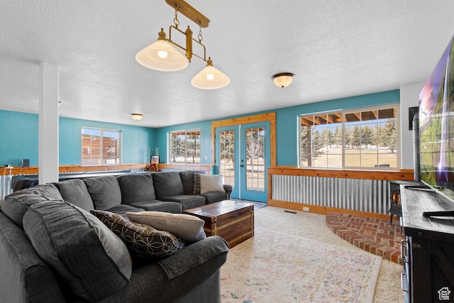 2599 S Foxridge Rd, Garden City, UT 84028 - carpeted living area featuring a textured ceiling, visible vents, and french doors