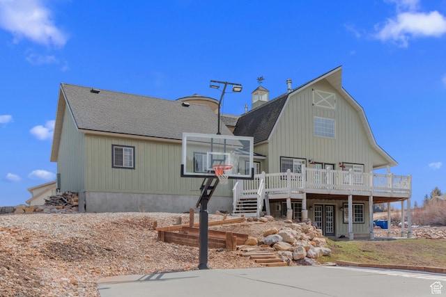 2599 S Foxridge Rd, Garden City, UT 84028 - back of property with a gambrel roof, a shingled roof, and a wooden deck