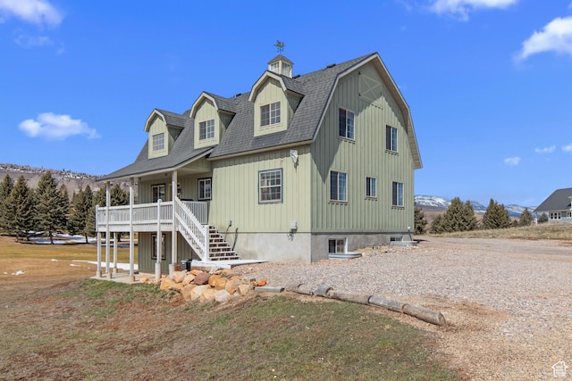 2599 S Foxridge Rd, Garden City, UT 84028 - view of front of property featuring stairs, a gambrel roof, and roof with shingles
