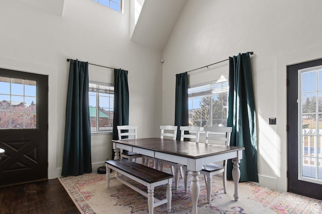 2599 S Foxridge Rd, Garden City, UT 84028 - dining area featuring high vaulted ceiling, wood finished floors, and a healthy amount of sunlight