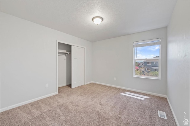 49 W Paper Bark St, Vineyard, UT 84059 - unfurnished bedroom featuring carpet floors, a textured ceiling, baseboards, visible vents, and a closet