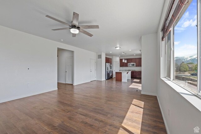 49 W Paper Bark St, Vineyard, UT 84059 - unfurnished living room with dark wood-style flooring, a ceiling fan, baseboards, recessed lighting, and visible vents