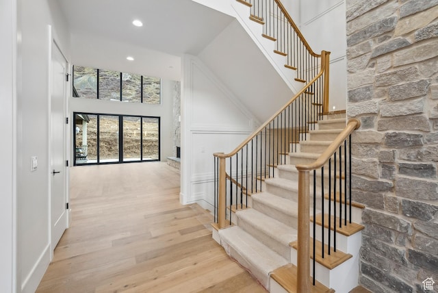 13042 N Prospector Way, Alpine, UT 84004 - stairs with a high ceiling, wood finished floors, recessed lighting, and a decorative wall