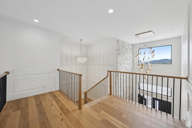 13042 N Prospector Way, Alpine, UT 84004 - hallway with an upstairs landing, a chandelier, wood finished floors, and recessed lighting