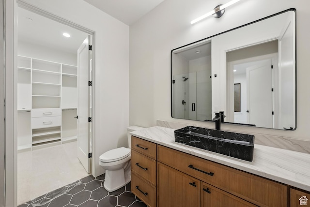 13042 N Prospector Way, Alpine, UT 84004 - bathroom featuring vanity, a shower with shower door, a spacious closet, toilet, and tile patterned flooring