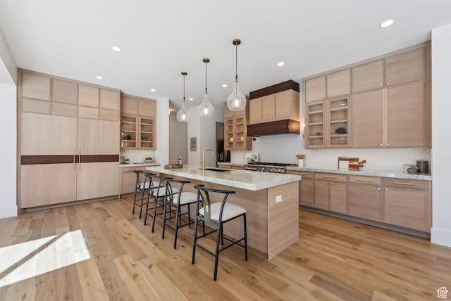 13042 N Prospector Way, Alpine, UT 84004 - kitchen with a breakfast bar, light wood-type flooring, a large island, a sink, and recessed lighting
