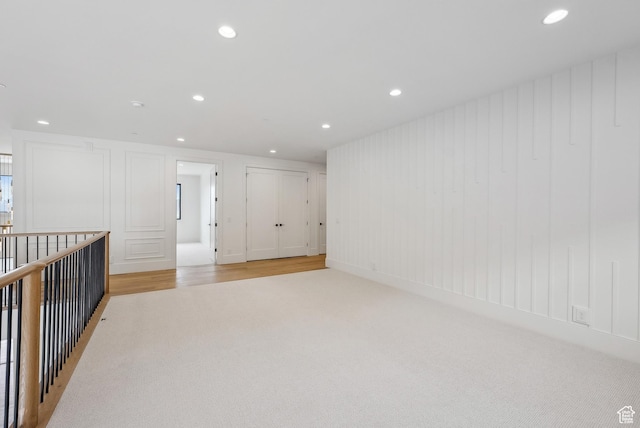 13042 N Prospector Way, Alpine, UT 84004 - empty room featuring light carpet, recessed lighting, and a decorative wall