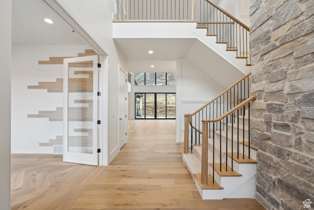 13042 N Prospector Way, Alpine, UT 84004 - foyer entrance with a towering ceiling, stairway, wood finished floors, and recessed lighting