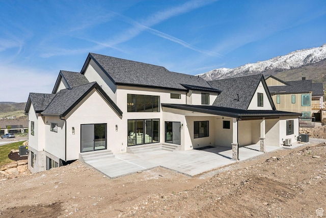 13042 N Prospector Way, Alpine, UT 84004 - rear view of property featuring stucco siding, a mountain view, a patio, and central AC unit
