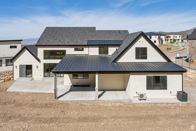 13042 N Prospector Way, Alpine, UT 84004 - back of property with a patio area, a standing seam roof, stucco siding, metal roof, and central AC unit