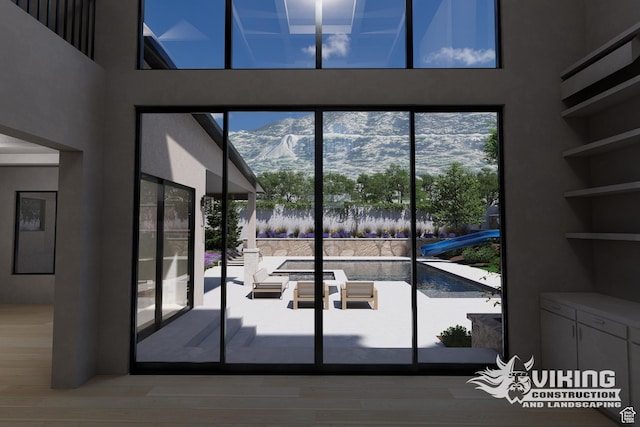 13042 N Prospector Way, Alpine, UT 84004 - doorway to outside with a towering ceiling, a mountain view, wood finished floors, and plenty of natural light