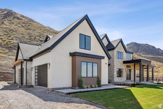 13042 N Prospector Way, Alpine, UT 84004 - back of property with a mountain view, a lawn, stucco siding, roof with shingles, and an attached garage