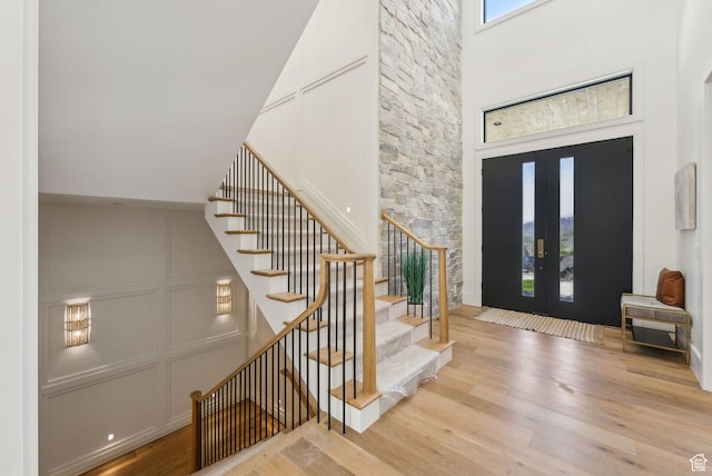 13042 N Prospector Way, Alpine, UT 84004 - entrance foyer featuring wood finished floors, stairs, french doors, and a high ceiling