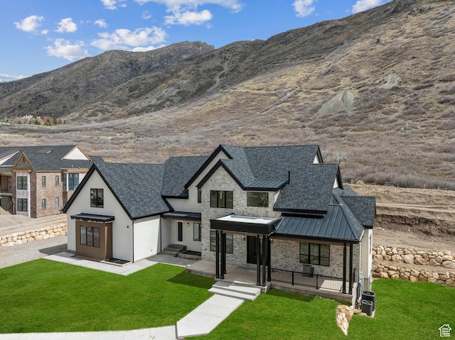 13042 N Prospector Way, Alpine, UT 84004 - view of front of home featuring a standing seam roof, a front yard, and a shingled roof