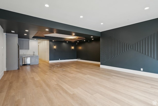 13042 N Prospector Way, Alpine, UT 84004 - unfurnished living room with baseboards, light wood-type flooring, recessed lighting, and a sink