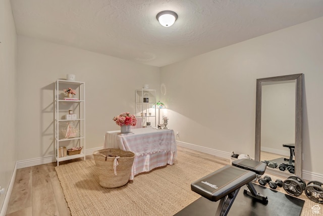 12483 N Timberline Dr, Highland, UT 84003 - exercise room with a textured ceiling, baseboards, and wood finished floors