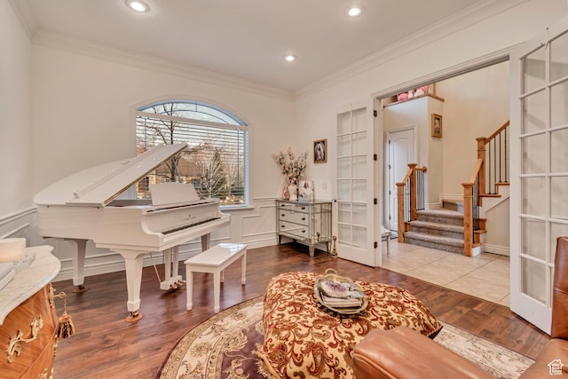 12483 N Timberline Dr, Highland, UT 84003 - living area with a wainscoted wall, a decorative wall, crown molding, wood finished floors, and stairway