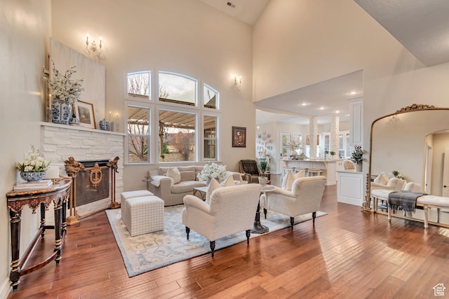 12483 N Timberline Dr, Highland, UT 84003 - living room with a fireplace, high vaulted ceiling, arched walkways, and wood-type flooring