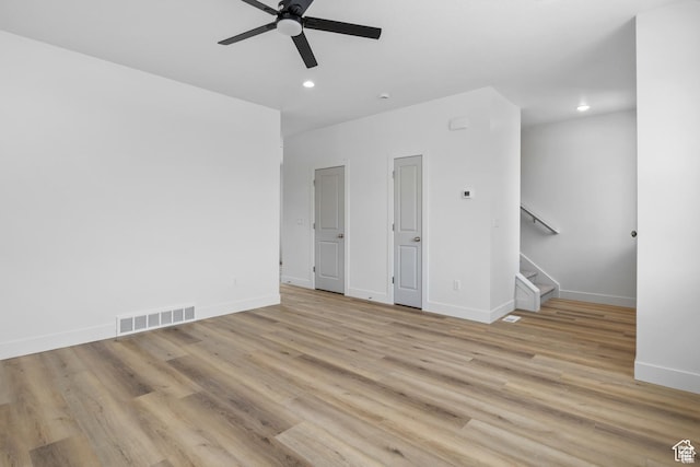 241 W 1160 N Unit 17, Tooele, UT 84074 - empty room with stairs, light wood-style floors, ceiling fan, and visible vents