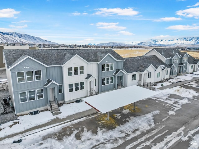 241 W 1160 N Unit 17, Tooele, UT 84074 - view of front facade featuring board and batten siding, central air condition unit, a mountain view, and entry steps