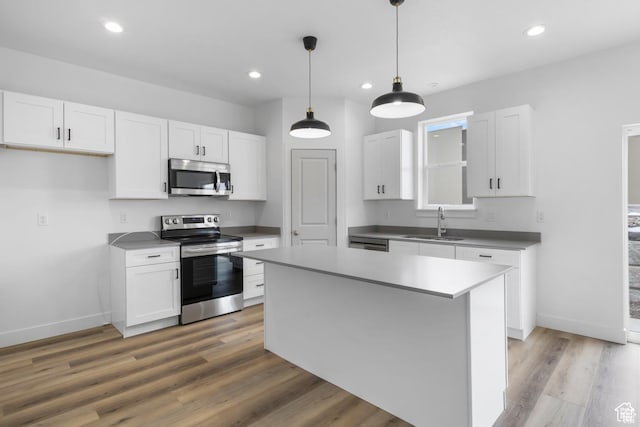 241 W 1160 N Unit 17, Tooele, UT 84074 - kitchen featuring white cabinets, a sink, stainless steel appliances, and light wood-style flooring
