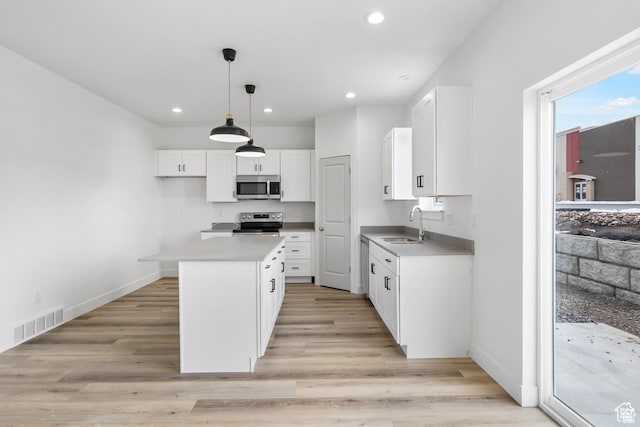241 W 1160 N Unit 17, Tooele, UT 84074 - kitchen with white cabinets, visible vents, stainless steel appliances, and light wood finished floors