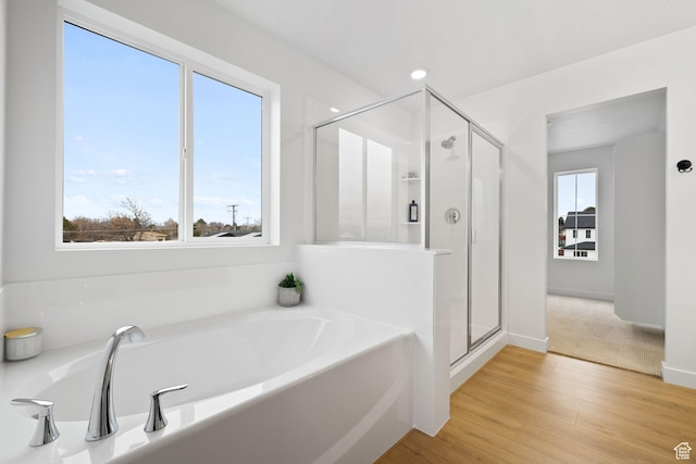 695 N Plainsman Dr Unit 110, Spanish Fork, UT 84660 - bathroom with a stall shower, a garden tub, wood finished floors, and baseboards