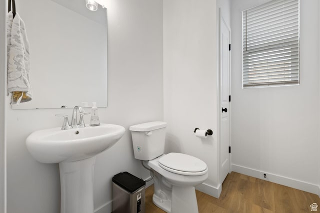 695 N Plainsman Dr Unit 110, Spanish Fork, UT 84660 - half bathroom featuring toilet, wood finished floors, and baseboards