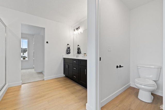 695 N Plainsman Dr Unit 110, Spanish Fork, UT 84660 - bathroom featuring toilet, baseboards, vanity, and wood finished floors