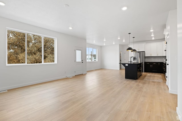 695 N Plainsman Dr Unit 110, Spanish Fork, UT 84660 - kitchen with recessed lighting, open floor plan, backsplash, and an island with sink
