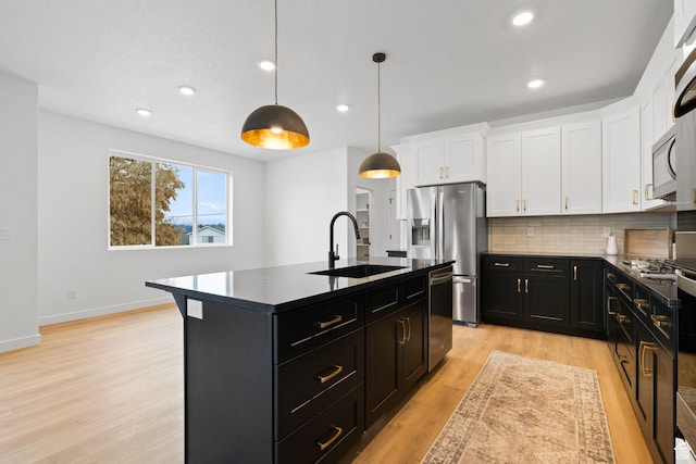 695 N Plainsman Dr Unit 110, Spanish Fork, UT 84660 - kitchen with dark cabinets, white cabinets, dark countertops, a sink, and stainless steel appliances